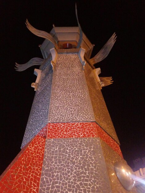 Low angle view of illuminated christmas tree on building