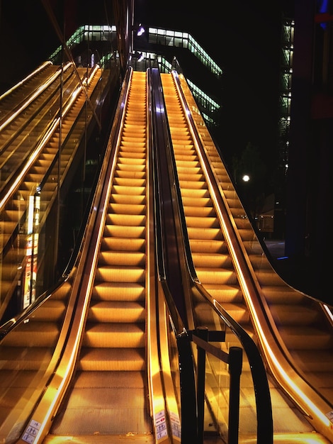 Low angle view of illuminated escalator