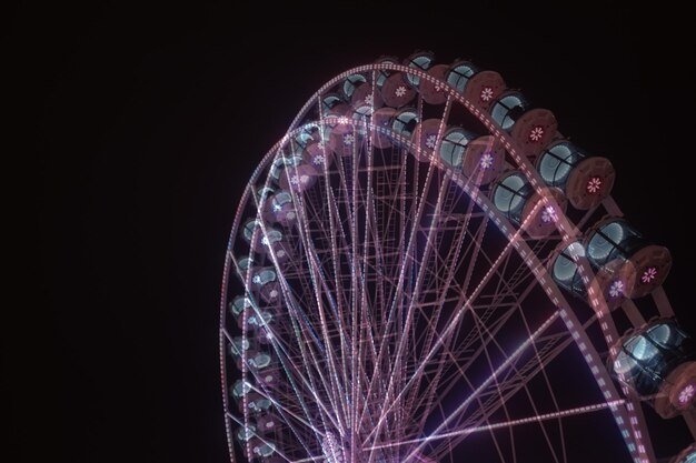 Photo low angle view of illuminated ferris wheel against sky at night