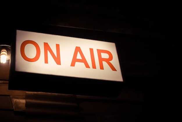 Low angle view of illuminated information sign in airplane