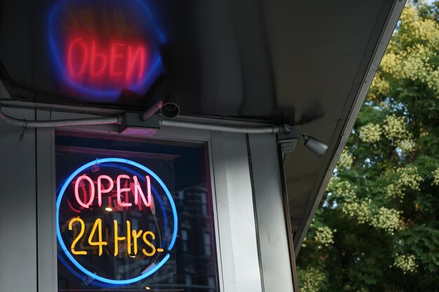 Photo low angle view of illuminated information sign on window