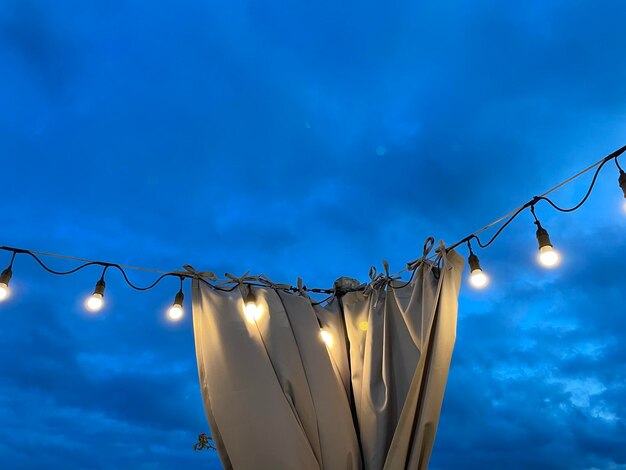 Low angle view of illuminated lamp against sky