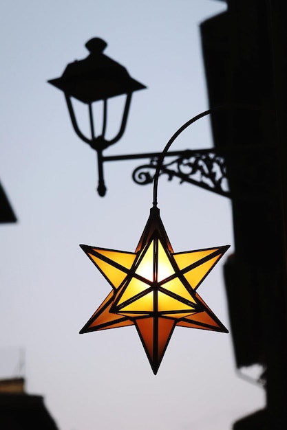 Low angle view of illuminated lamp against sky