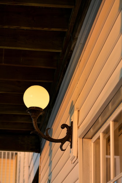 Photo low angle view of illuminated lamp on building