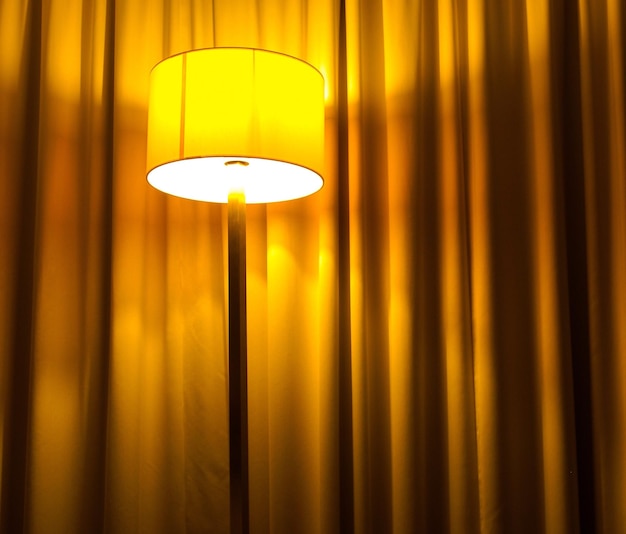 Low angle view of illuminated lamp at home