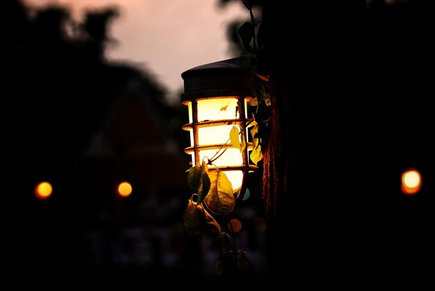 Low angle view of illuminated lamp at night