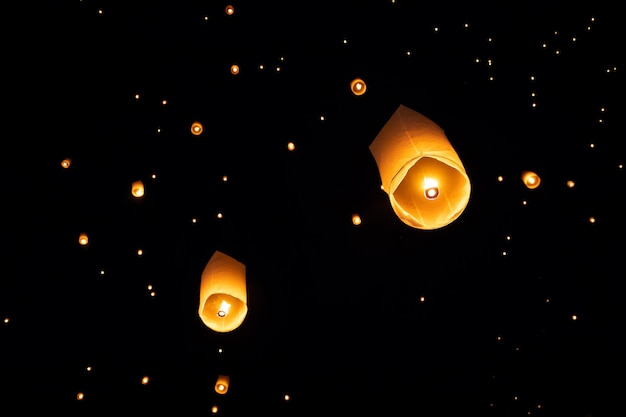 Low angle view of illuminated lantern against sky at night