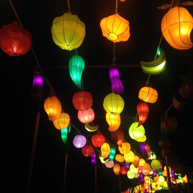 Low angle view of illuminated lanterns at night