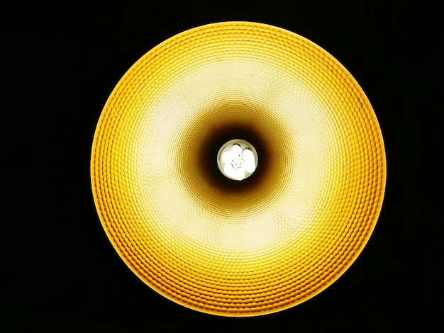 low angle view of illuminated light bulb against black background