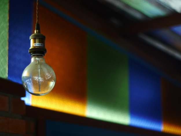 Low angle view of illuminated light bulb on table