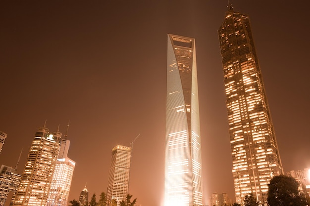 Low angle view of illuminated skyscrapers against sky at night