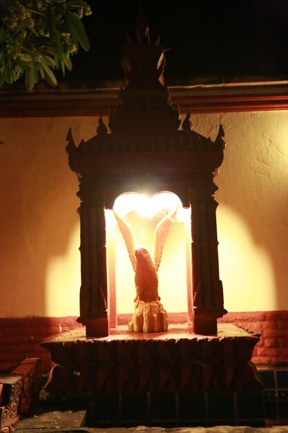 Low angle view of illuminated statue against sky at night