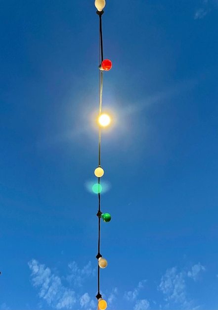 Low angle view of illuminated street light against blue sky be different even without shining