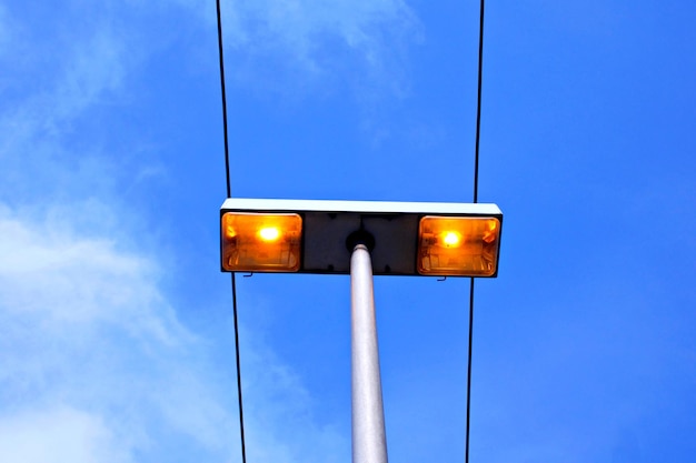 Low angle view of illuminated street light against sky