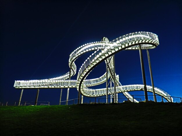 Low angle view of illuminated tiger and turtle against sky