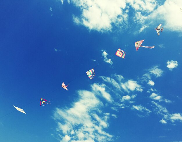 Low angle view of kite flying against blue sky