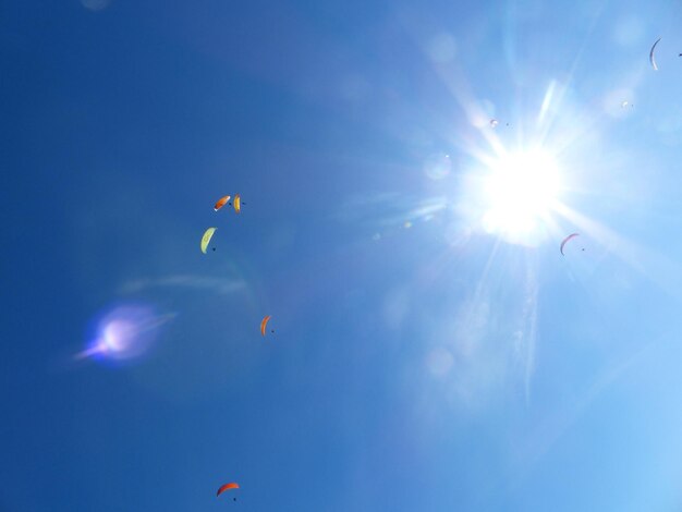 Low angle view of kite flying against clear blue sky