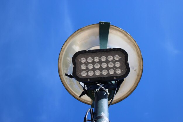 Low angle view of lamp against blue sky