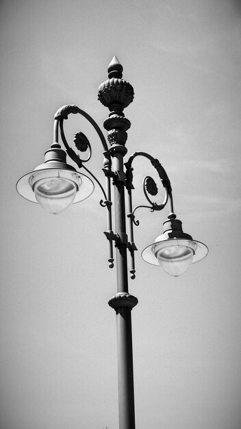 Low angle view of lamp post against sky