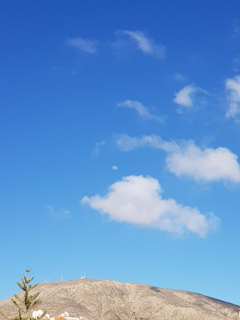 Low angle view of land against blue sky