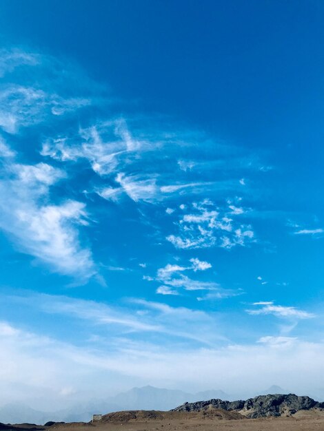 Low angle view of landscape against blue sky