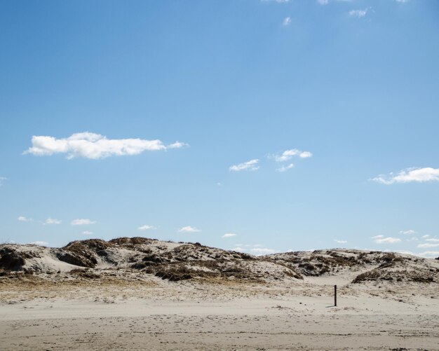 Low angle view of landscape against blue sky