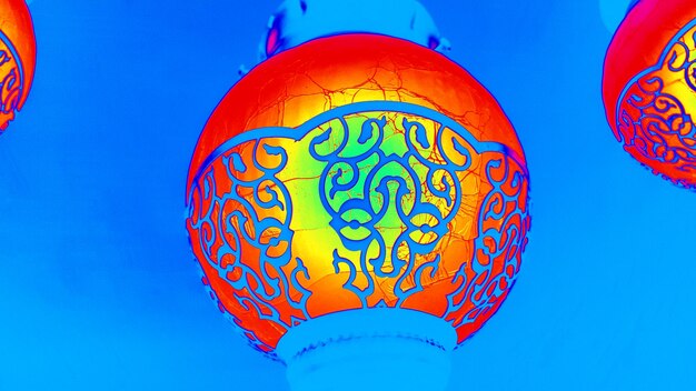 Low angle view of lantern against blue sky