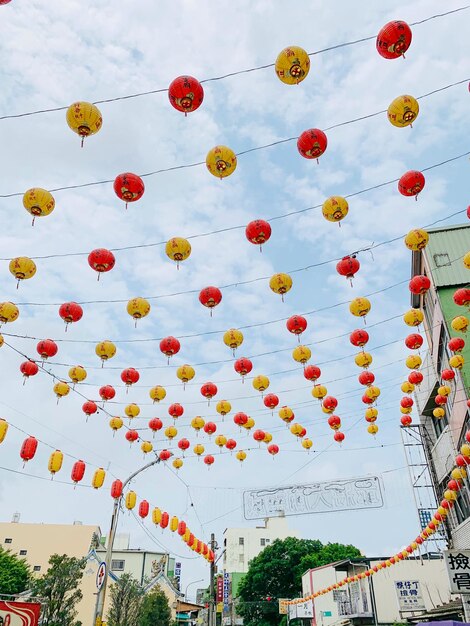 Low angle view of lanterns hanging against sky