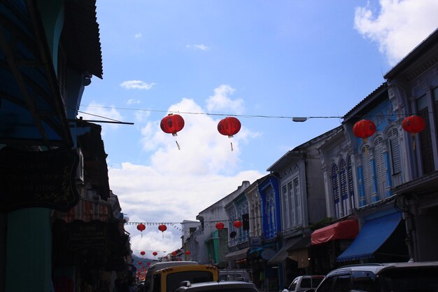 Low angle view of lanterns hanging amidst buildings in city