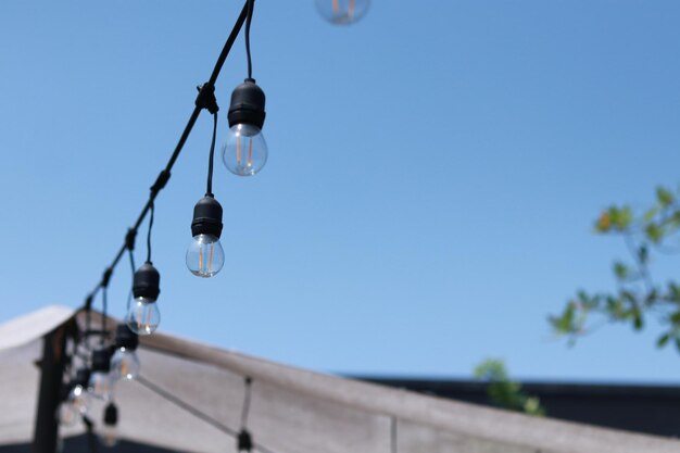 Low angle view of light bulb against clear sky