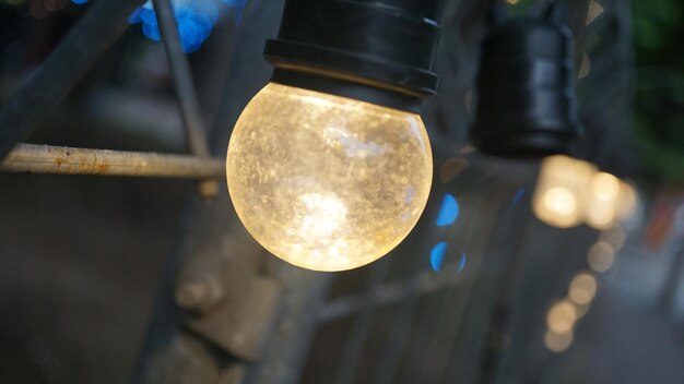 low angle view of light bulb hanging from ceiling