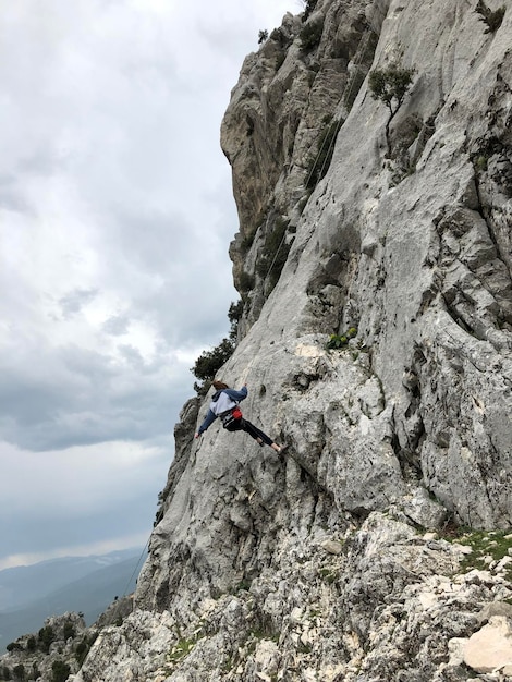 Low angle view of man climbing on mountain