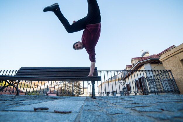 Low angle view of man jumping against clear sky