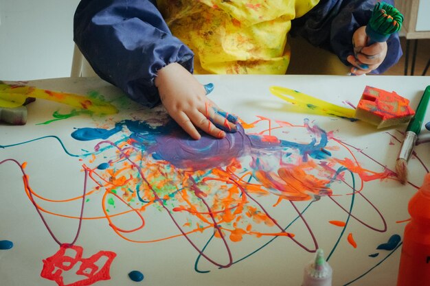 Photo low angle view of man painting on table