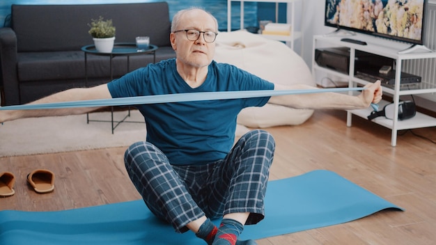 Low angle view of man sitting on sofa at home