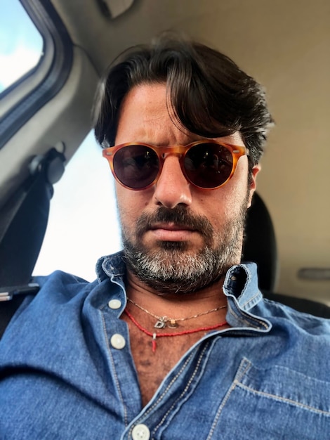 low angle view of man wearing sunglasses sitting in car