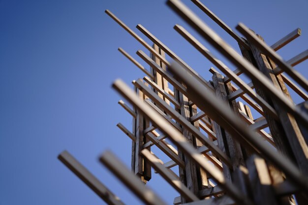 Low angle view of metallic structure against blue sky