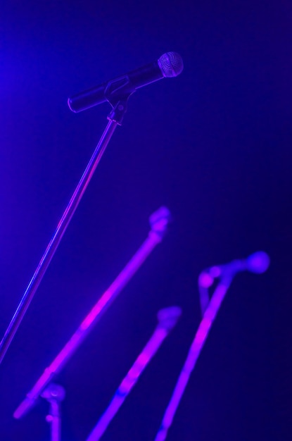 Low angle view of microphones on stage during illuminated music concert