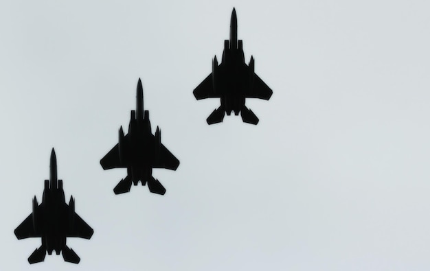 Low angle view of military airplanes flying against clear sky