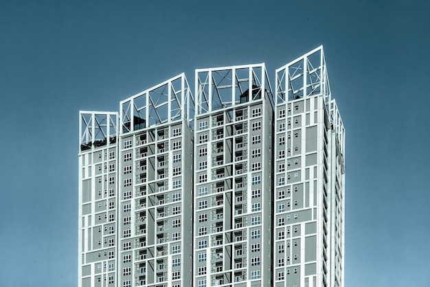 Low angle view of modern apartment building against clear blue sky