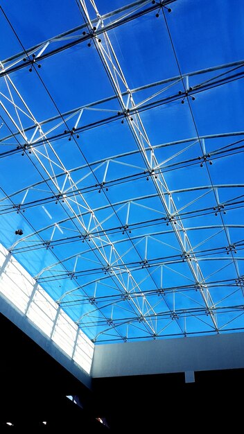 Low angle view of modern building against blue sky