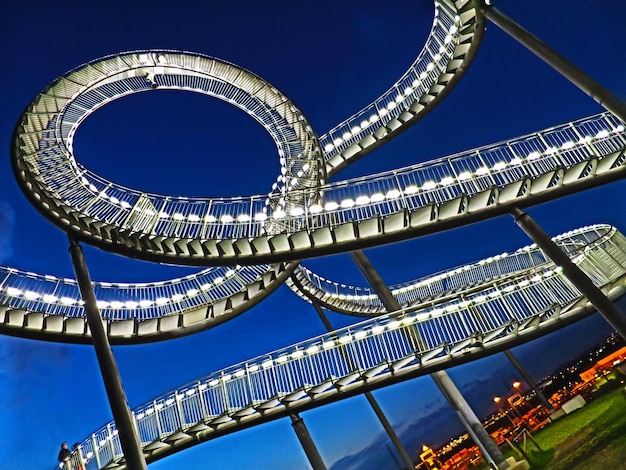 Low angle view of modern building against blue sky