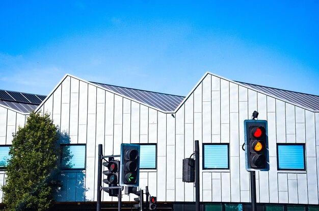 Low angle view of modern building against blue sky