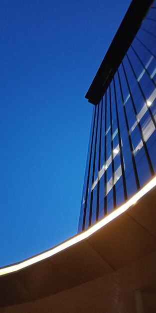 Low angle view of modern building against clear blue sky