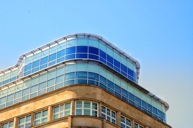 Low angle view of modern building against clear blue sky