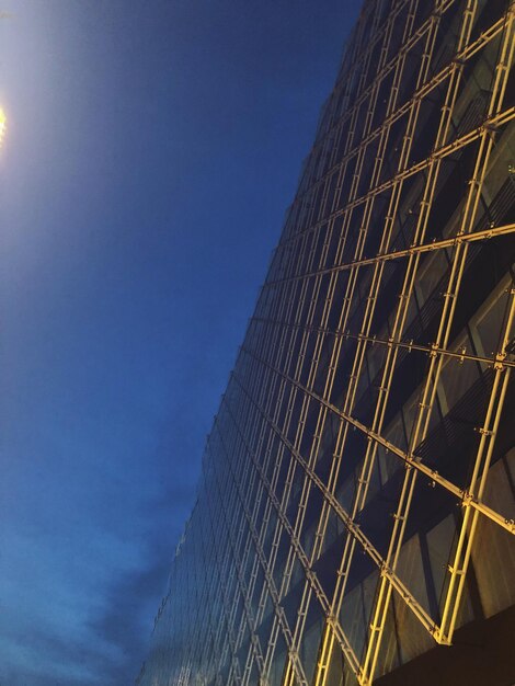 Low angle view of modern building against clear blue sky