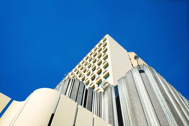 Low angle view of modern building against clear blue sky