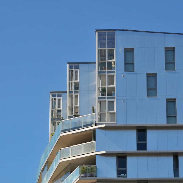 Low angle view of modern building against clear blue sky