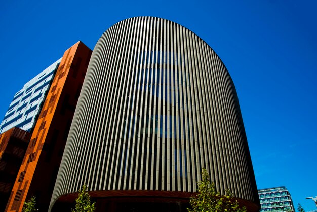 Low angle view of modern building against clear blue sky