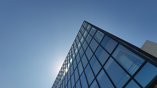 Low angle view of modern building against clear blue sky